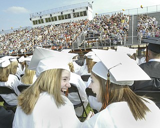 Springfield grads Erin Van Fosson, left, and Amber Uscianowski share a moment during Sunday commencement.