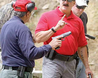 Glock Staff Instructor Joel Hodges of Florida explains technique to Robert Paterniti.