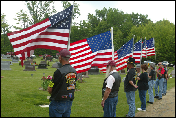 Members of the Patriot Guard Riders  honor guard hold flags for the funeral of Army Chief Warrant Officer S. Blane Hepfner at Hubbard Union Cemetery.
