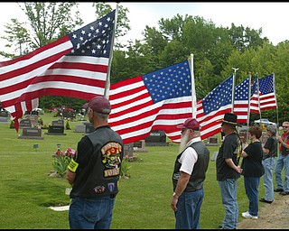 Members of the Patriot Guard Riders honor guard hold flags for the funeral of Army Chief Warrant Officer S. Blane Hepfner at Hubbard Union Cemetery.