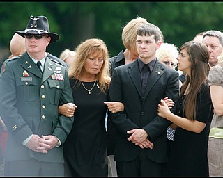 James Siebenaler, mother, Renee Possert, brother, William Panning and sister, Janelle, wait for the casket carrying their son and brother, Army Chief Warrant Officer S. Blane Hepfner, to be laid to rest at Hubbard Union Cemetery.