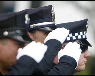 Hubbard police officers salute as Army Chief Warrant Officer S. Blane Hepfner is laid to rest at Hubbard Union Cemetery.