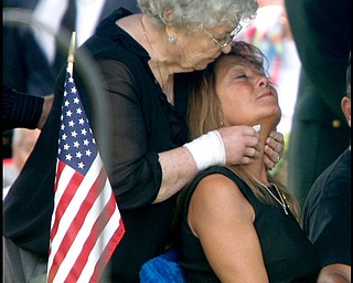 Renee Possert is comforted by her mother Rhodena Orr as Army Chief Warrant Officer S. Blane Hepfner is laid to rest at Hubbard Union Cemetery.