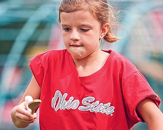 Courtney Thompson tries to balance a ball at Poland North Elementary's PTO-sponsored carnical on teh last day of class.