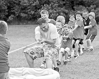 TUG OF WAR: Mike Zembower, a parent volunteer at the PTO of North Elementary, pitches in to help the Red Team. The PTO at Poland North Elementary put on a carnival on the last day of class for the students.