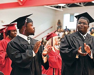 Edward V. Adams II and Carl Anderson II stand and applaud their loves ones during Class of 1992 President and Valedictorian Dr. Lionel M. Nelson, D. MD.'s commencement address at Campbell Memorial High School's Class of 2009 Graduation, Thursday June 11, 2009,.