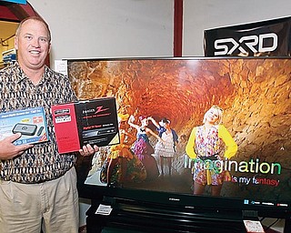Terry Semachs of Semachs holds two different types of digital TV tuners.