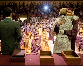 6.13.2009
Donald DeChellis hugs his mother, Delaine DeChellis, President of South Range Board of Education while on stage to receive his diploma during the South Range commencement ceremony in the school's gymnasium on Saturday afternoon.
