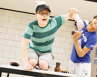 John Gluckner (18) gets salted by Kiyan Taghaboni (15) during practice for Boardman Community Theatre's  "Honk!" (which is based upon Hans Christian Andersen's "The Ugly Duckling" ) in the hallway of the Boardman Performing Arts Center, Thursday June 18, 2009