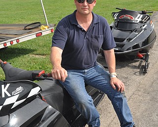 Karl Kridler of North Lima poses with his snowmobile that he drag races at the Steel Valley Super Nationals at Quaker City Raceway.