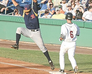 Jason Smit (6) of the Scrappers beats the throw as Kyle Morgan is pulled off the bag during the game Monday, June 22, 2009.