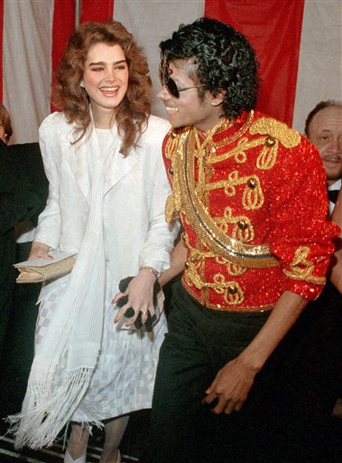 FILE - In this Jan. 16, 1984 file photo, actress Brooke Shields, left, and singer Michael Jackson are full of smiles as they arrive for the 11th Annual American Music Awards in Los Angeles. (AP Photo/Doug Pizac, file)