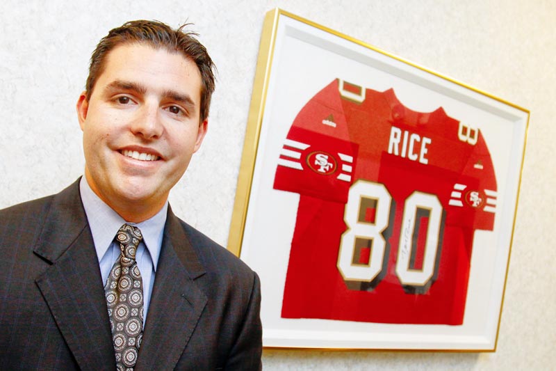 Jed York stands next to a Jerry Rice jersey at DeBartolo Corporation in Boardman, Monday June 29, 2009.