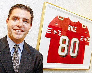 Jed York stands next to a Jerry Rice jersey at DeBartolo Corporation in Boardman, Monday June 29, 2009.