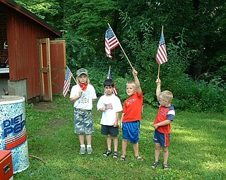 Danielle, Mario and Aniello Buzzacco of Canfield and Dominic Joseph of Youngstown (second from left) are marching their colors at their Papa’s annual Fourth of July party in 2003.