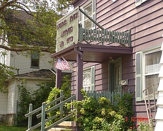 Ian Andrews says flags were placed on this Midlothian Boulevard building last year to celebate the Fourth of July as a small, low-cost symbol that the building is cared for and the neighborhood is regenerating and transforming slowly into a real “heart of Midlothian.” The same was being done this year.