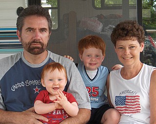 All dressed up in red, white and blue and thinking every day of their daddy, who is serving in Afghanistan, are Alex and Allison Courson, who are spending the holiday this year with Grandpa and Grandma Semchee.