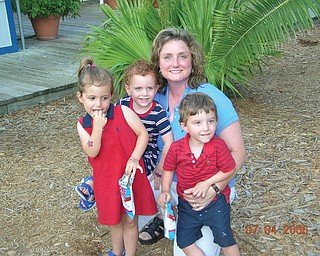 Erin Angelo of Canfield is surrounded by her triplets, Sydney, Madison and Trey, during a family vacation to Hilton Head Island in 2006.