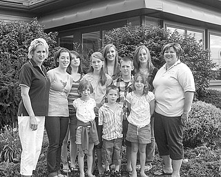 <p>Special to The Vindicator</p>
<p>FAMILY PLAN: With plans completed for a benefit golf outing sponsored for the Tom Driscoll family by Boardman-Poland Junior Women’s League, co-chairs of the event, Yvonne Ford, at left, and Linda Crish, at right, are joined by nine members of the family.</p>