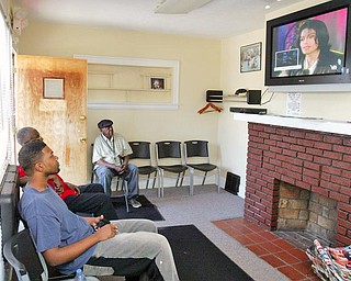 Watching TV coverage of Michael Jackson' funeral while waiting for haircuts at Legends Barbershop in Youngstown are from left are: Vincent Thomas, Kenneth McIntosh and James King, all of Youngstown.