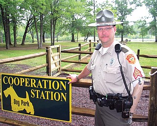 Sgt. Kevin Kuriatnyk, a park officer at Mosquito Lake State Park,
stands near the entrance to the nearly complete Cooperation Station
leashless dog park. The park is located inside Mosquito Lake State
Park near the beach. The project was a joint effort of the state park
and the Trumbull County MetroParks Board. The official grand opening
will be at 1 p.m. July 17.