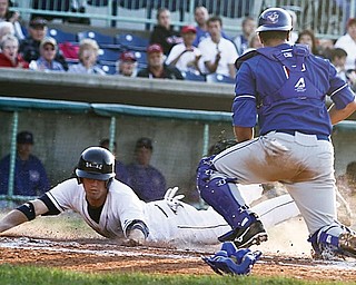 Scrappers Kyle Bellows (22) slides into home plate safely before Auburn Doubledays catcher Yan Gomes (5) can get him out during the 4th inning, Tuesday July 7, 2009
Lisa-Ann Ishihara