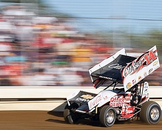 7.7.2009
Tony Stewart races past bleachers full of fans during an early heat race at Sharon Speedway on Tuesday evening.
Geoffrey Hauschild