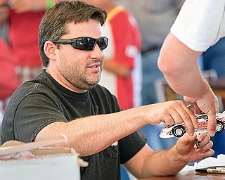 Tony Stewart signs autographs for fans at Sharon Speedway on Tuesday evening.