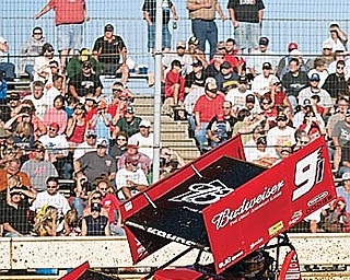 Kasey Kahne races past bleachers full of fans during an early heat race at Sharon Speedway on Tuesday evening.