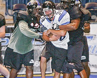 Former YSU quarterback Tom Zetts is wrapped up by defense during af2 Mahoning Valley Thunder practice.