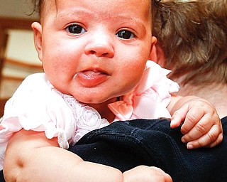 Halle Smith is held by her grandmother, Barb Enyeart. Halle's mother, Jenny, got infected with a flesh-eating bacteria after she was born.