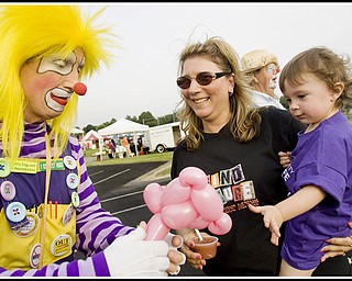 7.10.2009
Gianna Bindas, 1, wears the purple shirt signifying a cancer survivor, while being held by her mother, Michelle Bindas, both of Poland, and receiving a balloon animal from "Woodee" the Clown, also known as Joe Humansky, of Columbiana, during the Relay For Life at Poland's High School Stadium on Friday evening. Diagnosed at 9 months with a Wilms Tumor, Gianna has since had surgery, 21 weeks of chemotherapy, and despite loosing a kidney, her parents say she is "doing real good."
Geoffrey Hauschild