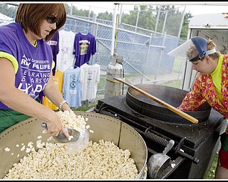7.10.2009
Rebecca Fisher, of Girard, scoops kettle corn along side her daughter in order to raise money during the Relay for Life at Poland's High School Stadium on Friday afternoon. Rebecca wears a purple shirt symbolizing her survival of skin cancer which she was diagnosed with in 1998.
Geoffrey Hauschild