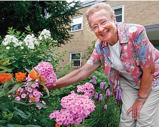 Sister Mary Ann, 90, has transformed the gardens with her green thumb - and proudly talks about her flowers plants and trees like family.