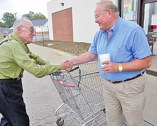 Henry Nemenz ,Poland Save A Lot store owner, RIGHT, greets longtime shopper Thomas Ziccardi 87 of Poland outside the store. wd lewis