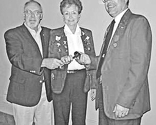 Special to The Vindicator
PASSING MOMENT: A highlight of the joint Austintown Lions and Lioness installation ceremony was the moment when David Gauch, installing officer, at left, presented a gavel to Lioness president Lori Stone and Lions president Jack Kochansky.