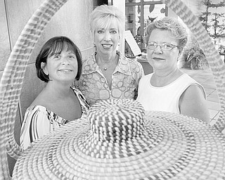 The Vindicator/William D. Lewis
HAVING A PARTY: Framed in one the baskets that is on display as part of the “A Southern Bash” summer garden party planned by Friends of Fellows Riverside Garden are committee members, from left, Sharon Letson and Becky Tennant and event chair Catherine Powers.