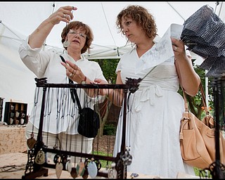 7.11.2009
Phyllis Ross, of Youngstown, shows a necklace to her daughter, Carla Duda, of Berlin Center, while shopping at Tom and Nancy Davidson's Japanese and Chinese Ceramics on YSU campus during the YSU Festival of the Arts on Saturday afternoon.
Geoffrey Hauschild