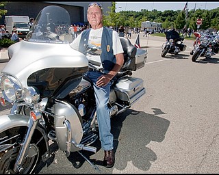 7.12.2009
Bob Hudak, a retired Youngstown Police Officer and resident of Boardman, sits on his motorcycle outside the Covelli Centre before 7th Annual Fallen Officers Memorial Run in downtown Youngstown on Sunday afternoon. A twenty plus year veteran of the YPD, Hudak, now 72, has participated in all seven of the annual rides, having been friends with Howard Hertzell, after whom the event was originally named.
Geoffrey Hauschild