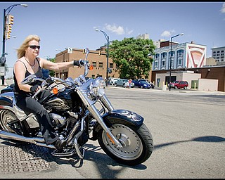 7.12.2009
Marsha Caron, of Boardman, pulls out of the Covelli Centre onto Front St embarking on the 7th Annual Fallen Officers Memorial Run in downtown Youngstown on Sunday afternoon. "I love the ride," says Caron who has participated in all seven of the annual rides.
Geoffrey Hauschild