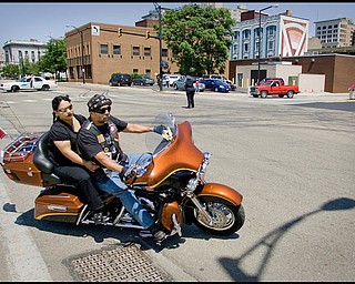 7.12.2009
(LEFT TO RIGHT) Damaris and Boniface Santana, both of Campbell, pull out of the Covelli Centre onto Front St embarking on the 7th Annual Fallen Officers Memorial Run in downtown Youngstown on Sunday afternoon. The two, riding with the Latin America Motocycle Association, have participated in evey ride since the events conception seven years ago.
Geoffrey Hauschild