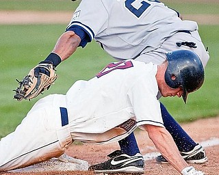The Scrappers' Jordan Henry arrives safely at third base beating the throw to Staten Island Yankee Kelvin Castro during the bottom of the sixth inning at Eastwood Field on Wednesday evening.
