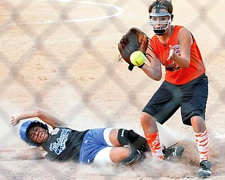 Poland's Arlia Duarte slides into home base before Howland's Navdia Pate can catch the ball during the second inning at the Field of Dreams in Boardman.