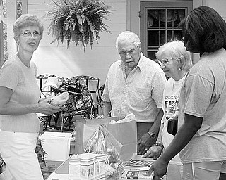 Special to The Vindicator
BUYERS AND BROWSERS: There will be something for everyone at the annual garage sale to be sponsored by the Harriet Taylor Upton Association at the Upton House, 380 Mahoning Ave. NW, Warren, from 9 a.m. to 4 p.m. July 24 and 25. Browsers, who may eventually become buyers, get a sneak preview of some of the sale items as they are being set up for display by Carol Sager, at left. Although only potential customers, those who browse in advance will be able to quickly select the things they want when they participate in the sale. Proceeds will benefit the Upton House, a Victorian home that is available for parties and rentals. For additional information on the event or on the association, which also provides educational tours of the area, call (330) 395-1840 or visit www.uptonhouse.org.