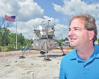 Dr. Patrick Durrell, YSU Professor of Astronomy, stands near replica of Lunar Lander in Warren.