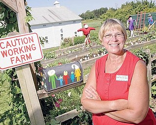 Lynn Zocolo, Asst. Horticulture Educator, stands for a portrait outside the gardens at the Mill Creek MetroParks Farm in Canfield on Wednesday afternoon. "These kids are learning when theyre having fun, entertainment is part of it," says Zocolo who also encourages education by having children grow new and different kinds of plants including bok choy, dinosaur kale, and red noodle beans, "but I just love to see them smile," she adds.