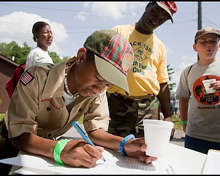 7.16.2009
Christian Thornton, of Pack 388 in South Euclid OH, adds his signature to those of others who have seen the 100 year commemorative mural traveling to all Scout Camps across the country while at Camp Stambaugh on Thursday afternoon.
Geoffrey Hauschild
