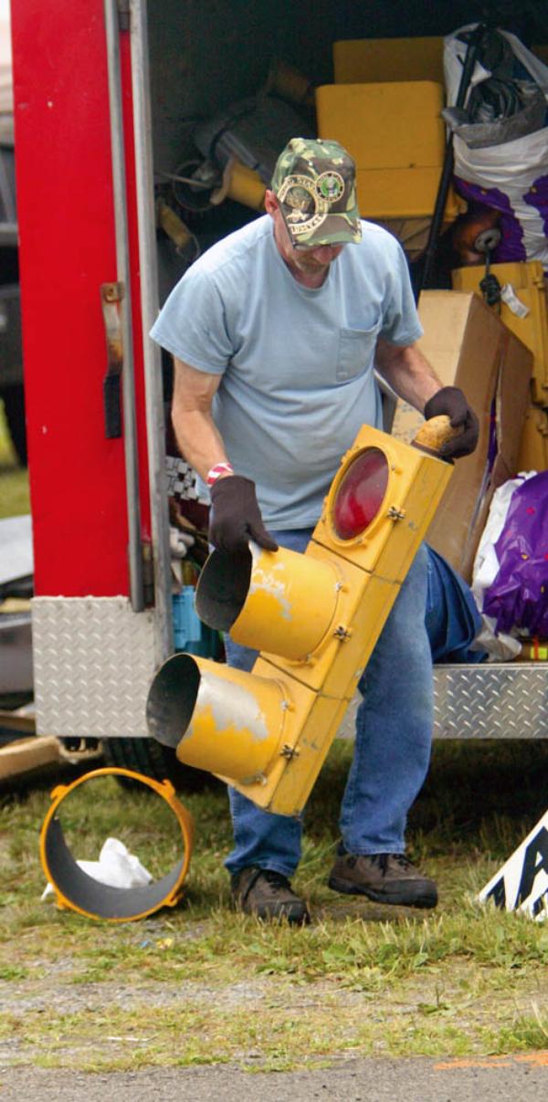 Paul Perelman of Chesterland puts out a traffic light at the Dave and Eds Swap Meet at the Canfield Fairgrounds.