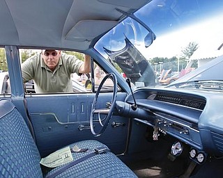 Rick Jenkins of Espyville, PA peers through the driver side window of his 1963 Chevy Bel Air Station Wagon during the collaborative car show with the  Mahoning Valley Corvettes and Greenwood Chevrolet in Austintown, Sunday July 19, 2009
Lisa-Ann Ishihara