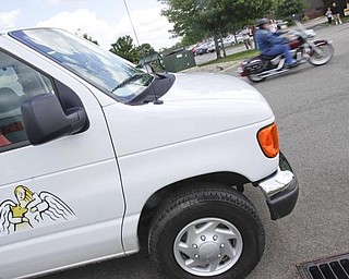 A biker rides past an Angels for Animals van in the parking lot of Harley Davidson Biketown in Austintown for the event to raise money for several charities.  Sunday July 19 2009

Lisa-Ann Ishihara